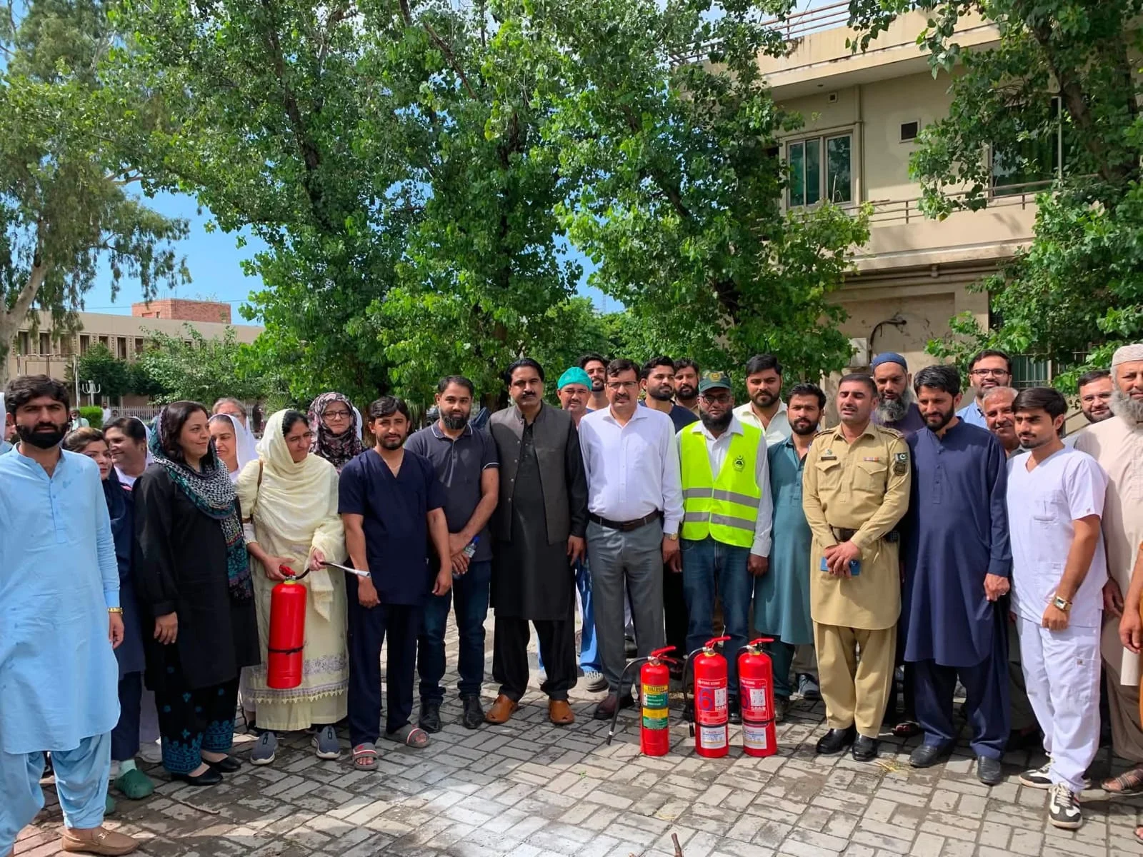 PIMS fire safety training group with fire extinguishers